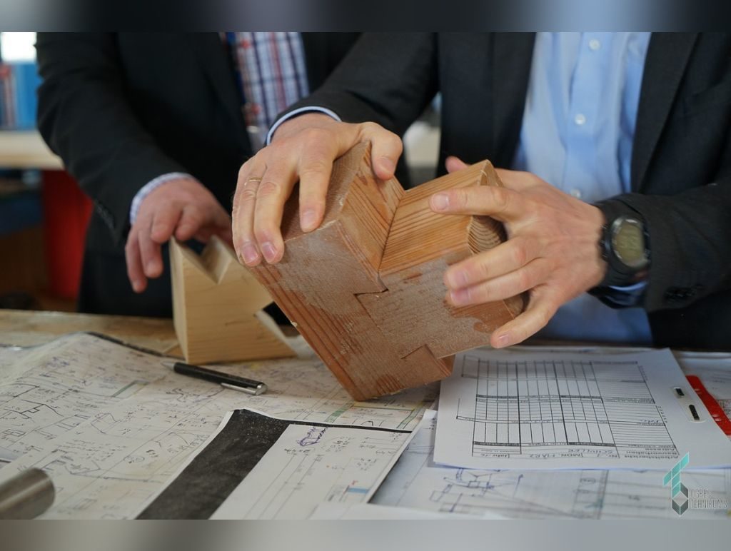 Craftsmanship detail being reviewed over technical plans